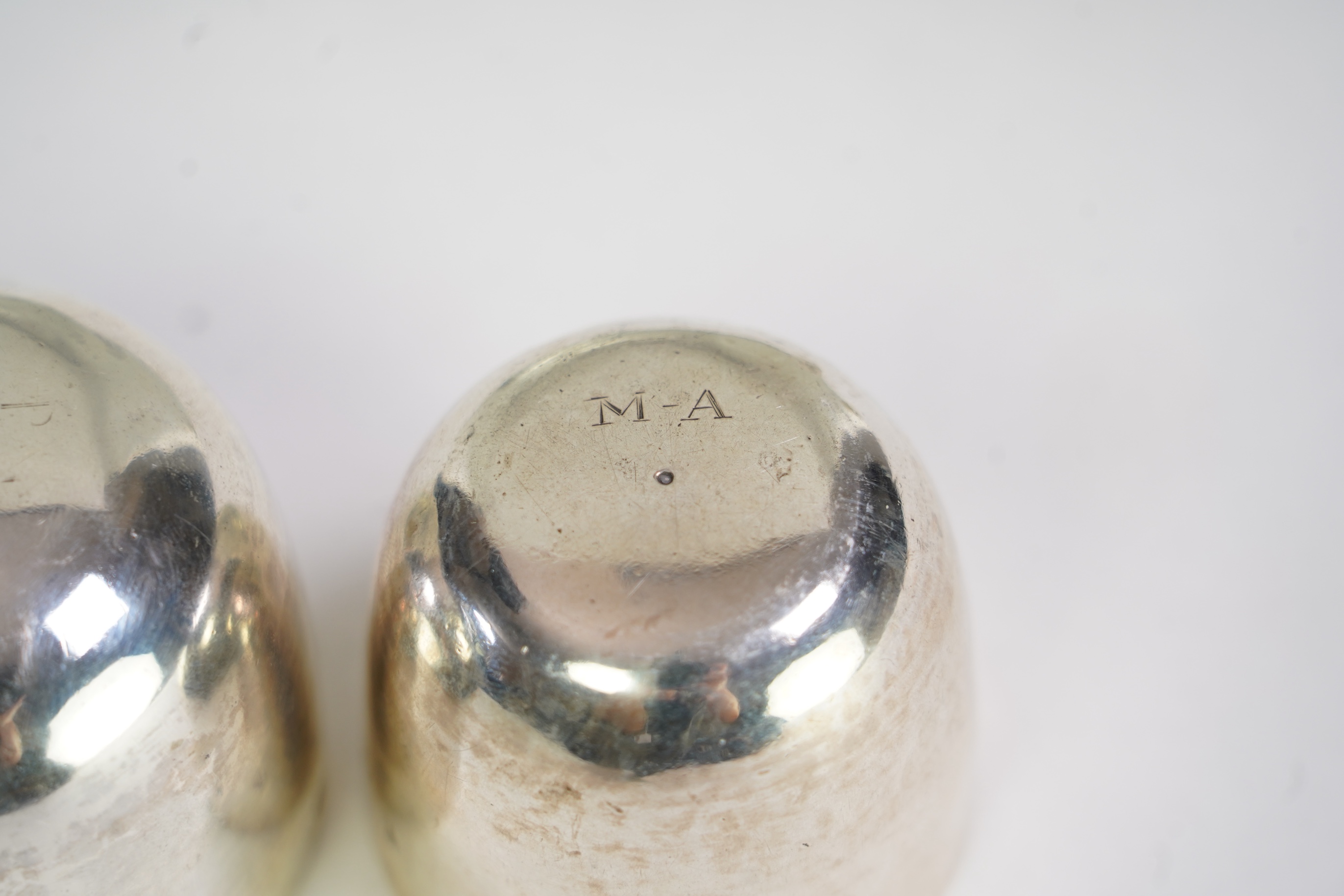 A George II silver tumbler cup by John Payne, London, 1753?, engraved with the initial MA, 45mm, together with a later George III silver tumbler cup by John Payne, London, 1766, engraved with the initials, A.M.A